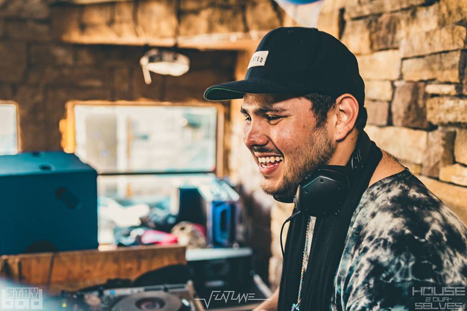 Susio smiling behind DJ booth